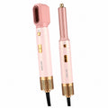 Green Lion 5-in-1 professional hair styler in pink and gold with multiple styling attachments.